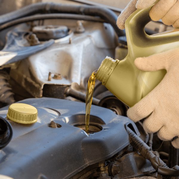 Synthetic Oil being poured into engine tank