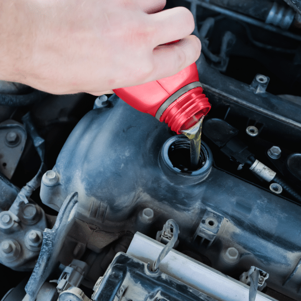 Redex 2 stroke oil being poured into car engine