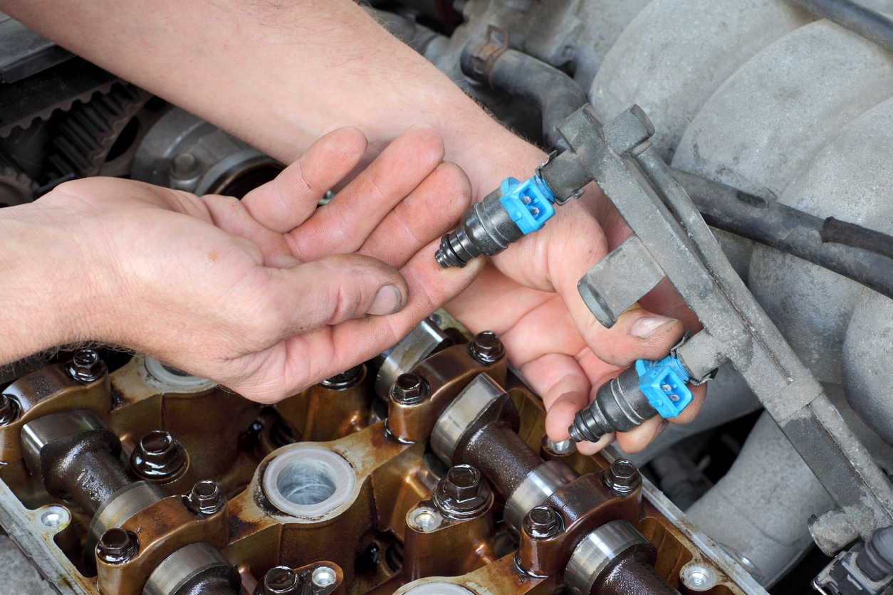 mechanic fixing fuel injector