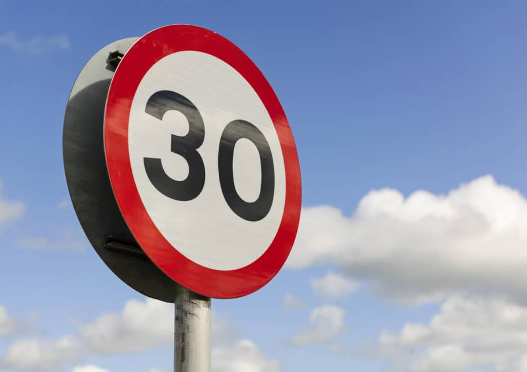 A British road sign for a 30 mile per hour speed limit area.