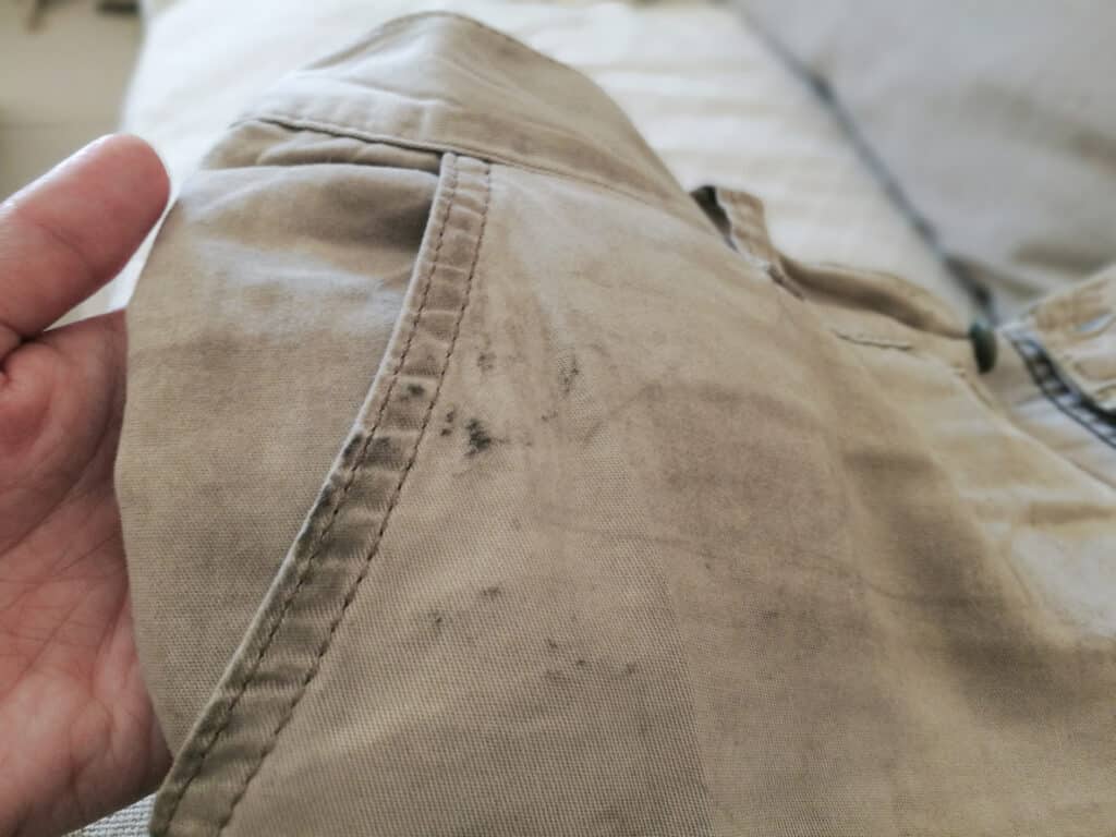 Image of brown trousers with oil stain on them.